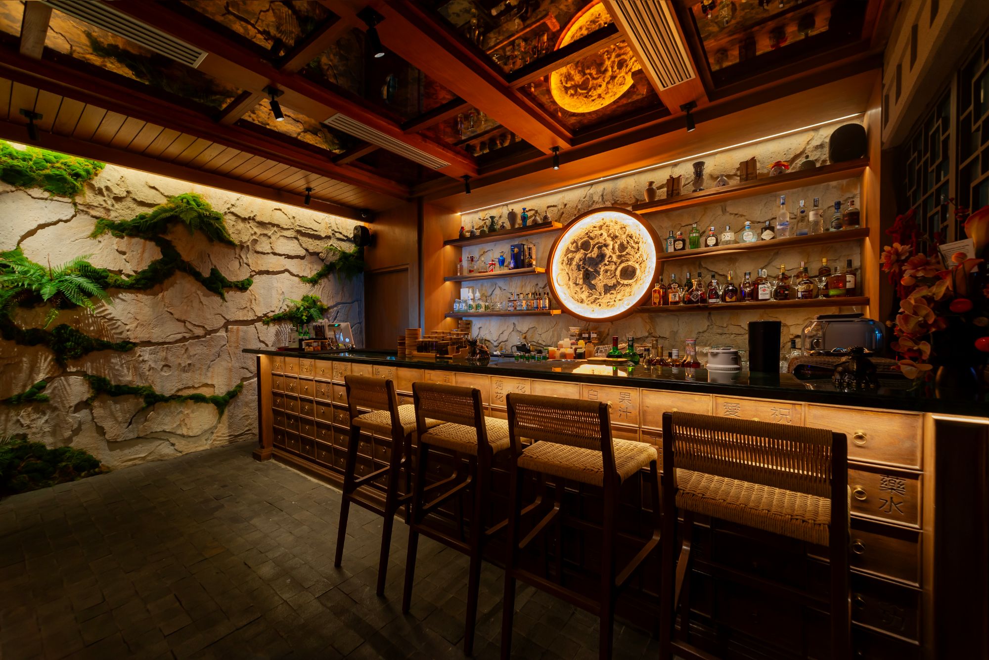 The moon bar at Apollo Wu, Jakarta: apothecary-drawer counter beneath a glowing moon